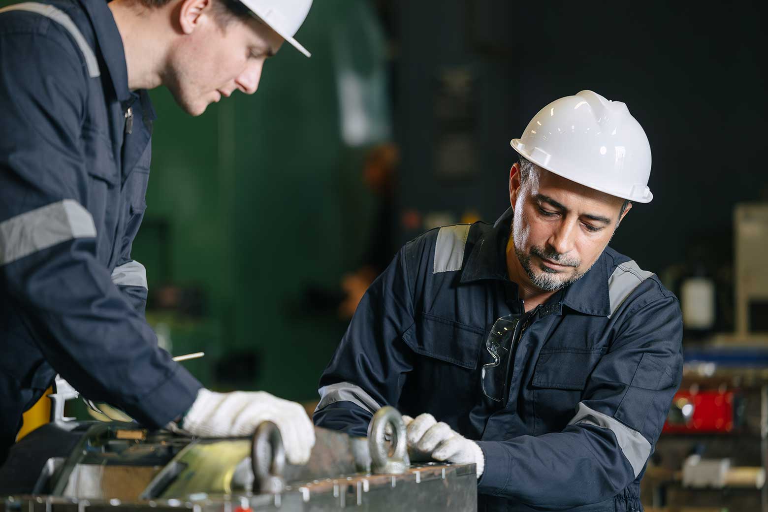 two factory workers working on injection moldings