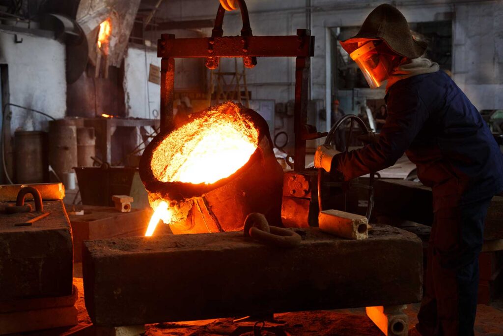molten metal being poured into metal castings mold